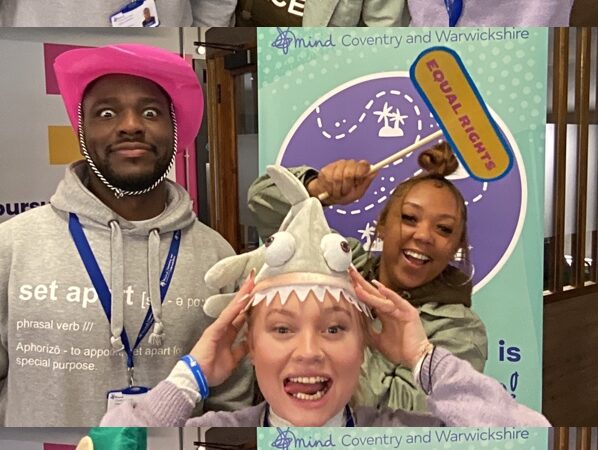 Three adults wearing silly hats