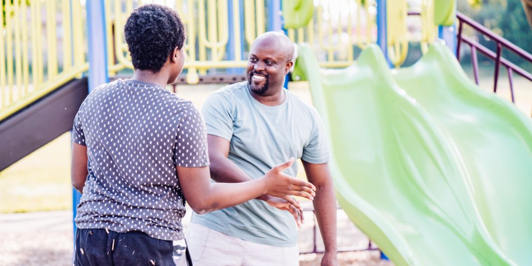 Dad and his teenager son in a park