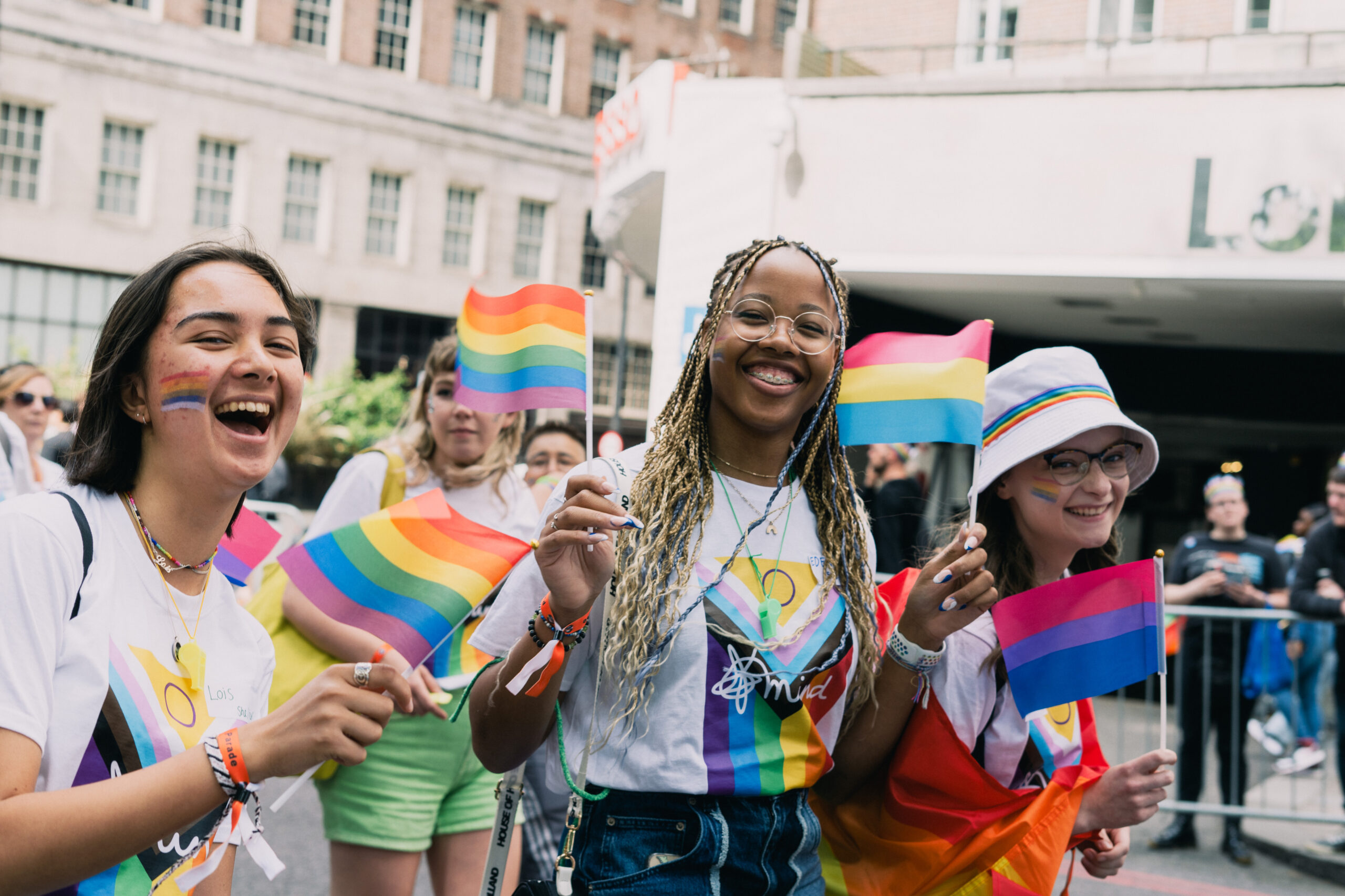 Group of young people with rainbow flags and t-shirts