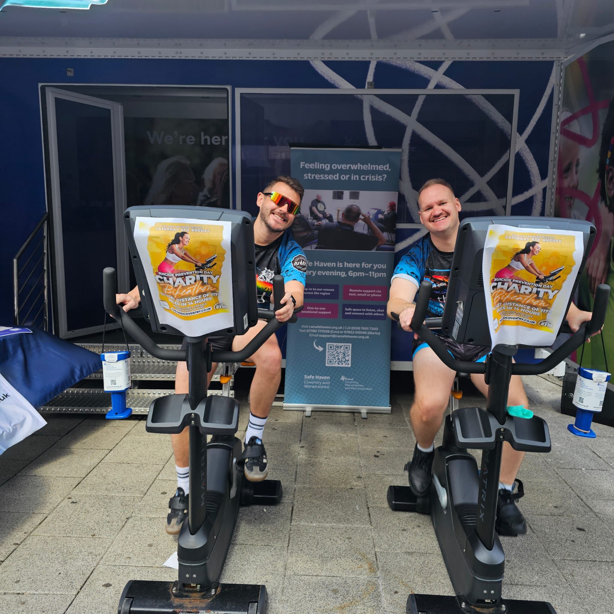 Two men cycling on exercise bikes