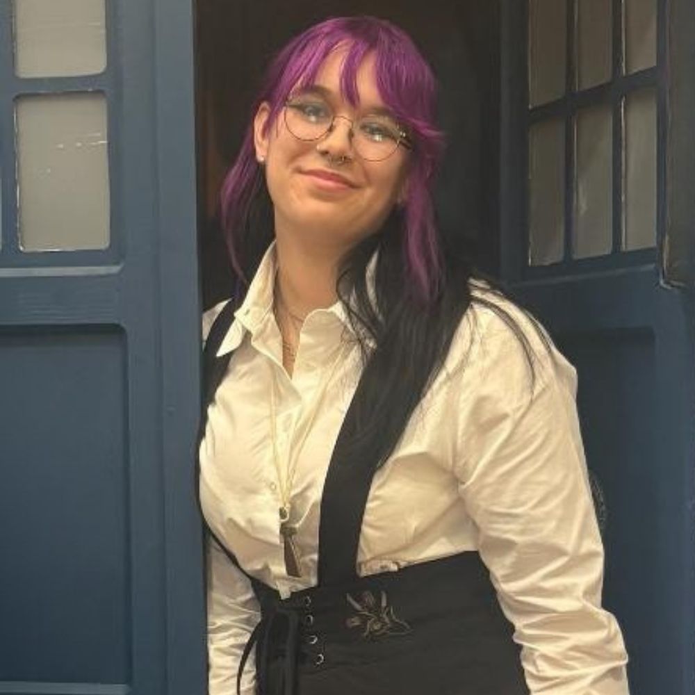 Young woman with purple hair and a white shirt