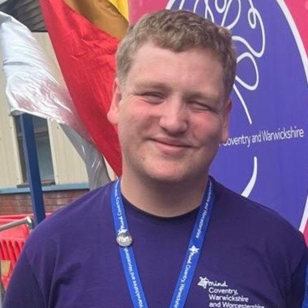 Young man with light hair and a blue t-shirt.