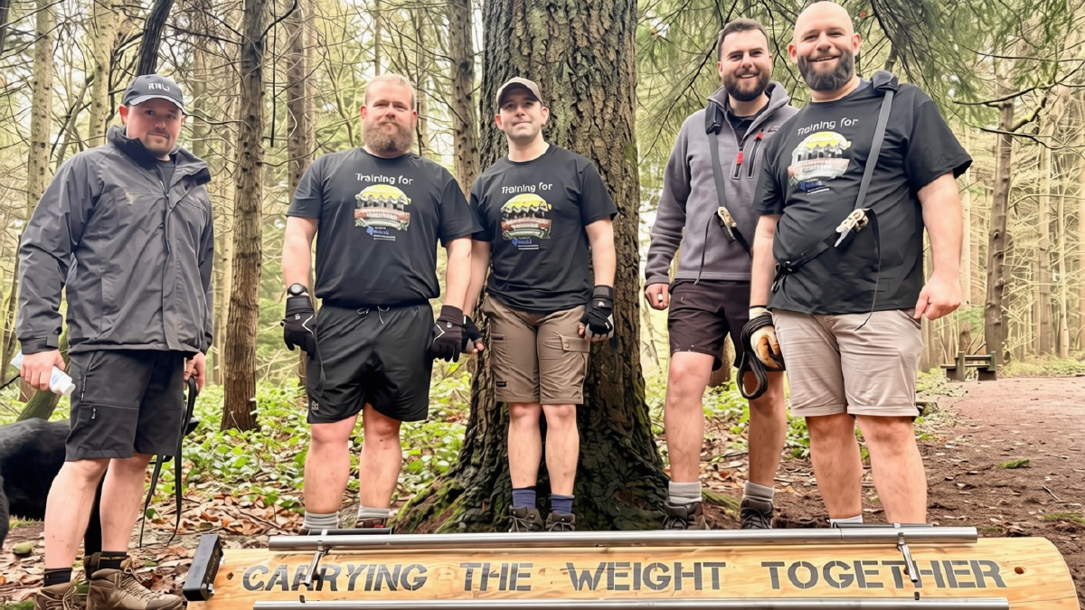 5 men carrying the weight